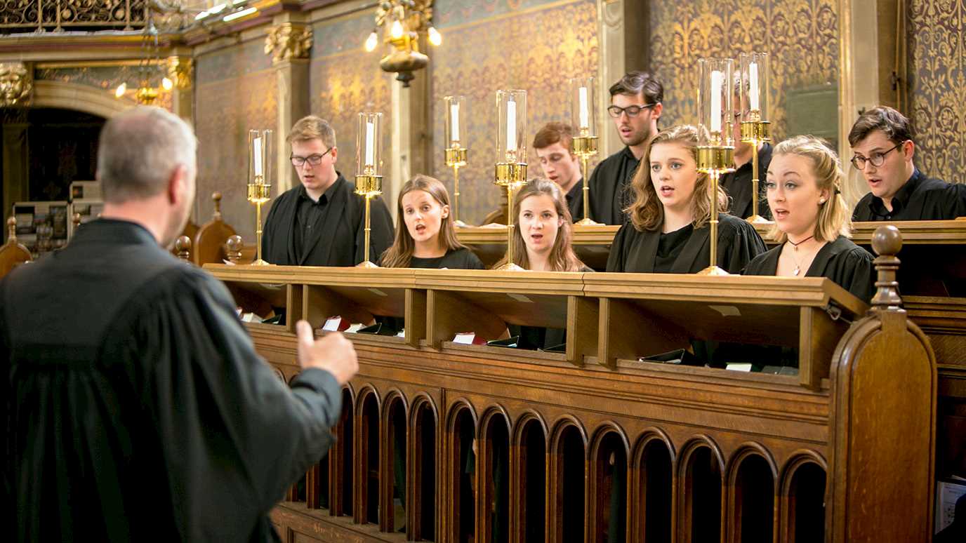 Rupert Gough conducting choir in chapel - Music